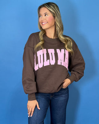 Chocolate brown Lulu Mac graphic crewneck sweatshirt with bold pink varsity lettering, long sleeves, ribbed trim, and a relaxed fit.