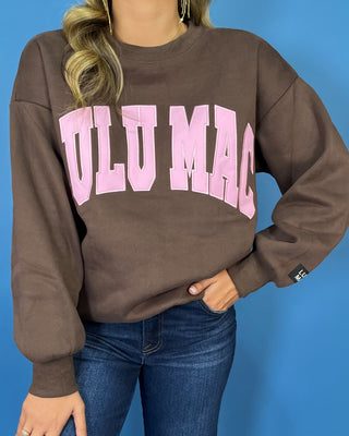 Chocolate brown Lulu Mac graphic crewneck sweatshirt with bold pink varsity lettering, long sleeves, ribbed trim, and a relaxed fit.
