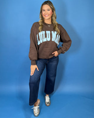 Chocolate brown Lulu Mac graphic crewneck sweatshirt with light blue varsity lettering, long sleeves, ribbed trim, and a relaxed fit.