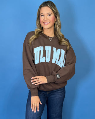 Chocolate brown Lulu Mac graphic crewneck sweatshirt with light blue varsity lettering, long sleeves, ribbed trim, and a relaxed fit.