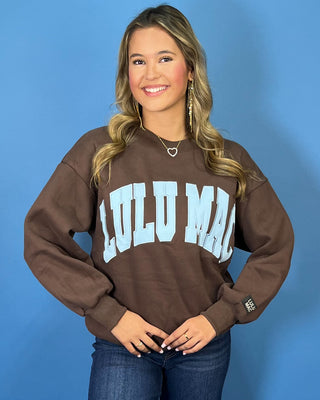 Chocolate brown Lulu Mac graphic crewneck sweatshirt with light blue varsity lettering, long sleeves, ribbed trim, and a relaxed fit.