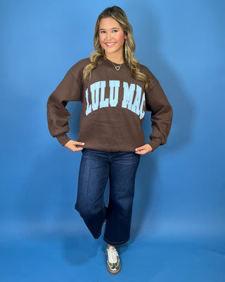 Chocolate brown Lulu Mac graphic crewneck sweatshirt with light blue varsity lettering, long sleeves, ribbed trim, and a relaxed fit.