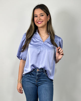 Soft, sleek, and effortlessly chic 💙 This silky lavender blouse features a flattering notched neckline and statement puff sleeves that instantly elevate your everyday denim—perfect for work, dinner, or anything in between!