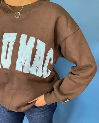 Chocolate brown Lulu Mac graphic crewneck sweatshirt with light blue varsity lettering, long sleeves, ribbed trim, and a relaxed fit.
