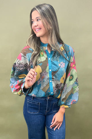 Woman wearing a colorful patterned shirt against a beige background