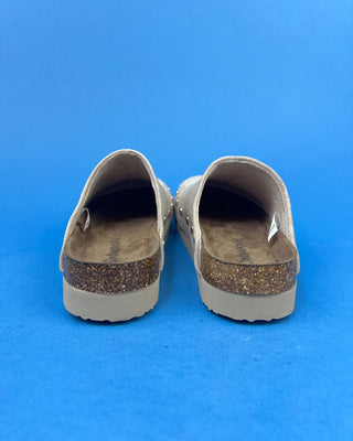 Nude suede-look slip-on clog mules featuring metallic round studs, closed rounded toes, and cork-look footbeds.