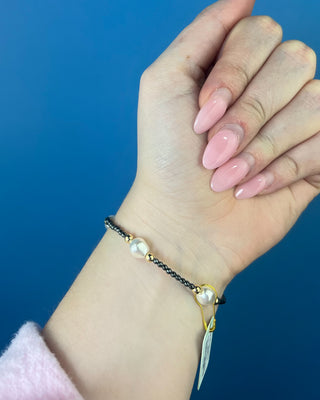Shop the Purpose Admire Pearl 8mm Hematite Bracelet by enewton, featuring dark hematite beads, white pearl accents, and elegant gold-tone details.