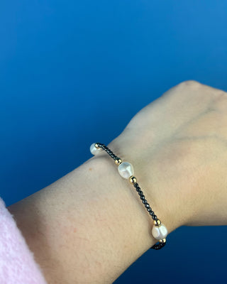 Shop the Purpose Admire Pearl 8mm Hematite Bracelet by enewton, featuring dark hematite beads, white pearl accents, and elegant gold-tone details.