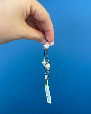 Shop the Purpose Admire Pearl 8mm Hematite Bracelet by enewton, featuring dark hematite beads, white pearl accents, and elegant gold-tone details.