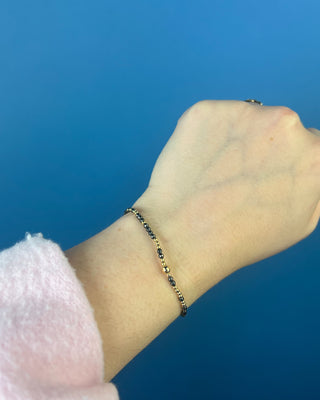 Shop the Hope Unwritten Faceted Hematite 2mm Bracelet by enewton, featuring dark faceted hematite beads and polished gold accents for everyday style.