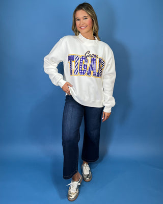White Geaux Tigers graphic sweatshirt with bold purple mixed-print lettering, gold accents, mock neckline, long sleeves, and a relaxed fit.