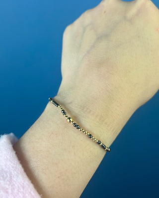Shop the Hope Unwritten Faceted Hematite 2mm Bracelet by enewton, featuring dark faceted hematite beads and polished gold accents for everyday style.
