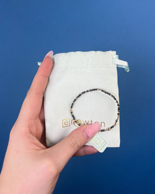 Shop the Hope Unwritten Faceted Hematite 2mm Bracelet by enewton, featuring dark faceted hematite beads and polished gold accents for everyday style.