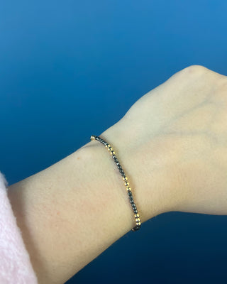 Shop the Joy Hematite 2mm Bracelet by enewton, featuring delicate dark hematite beads and polished gold accents. Perfect for everyday wear and layering.