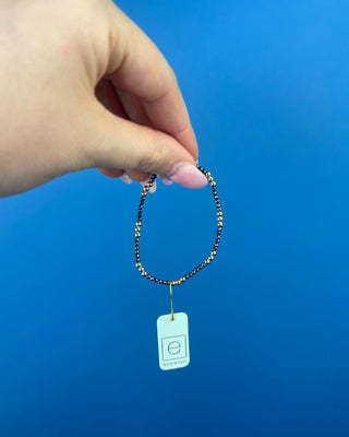 Shop the Joy Hematite 2mm Bracelet by enewton, featuring delicate dark hematite beads and polished gold accents. Perfect for everyday wear and layering.