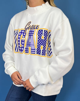 White Geaux Tigers graphic sweatshirt with bold purple mixed-print lettering, gold accents, mock neckline, long sleeves, and a relaxed fit.