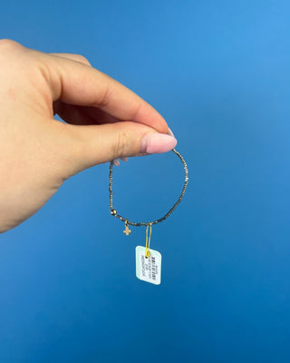 Shop the Hope Classic Signature Cross Moonlight Bracelet by enewton, featuring smoky gray beads and a delicate gold cross charm. Perfect for everyday wear.