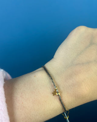 Shop the Hope Classic Signature Cross Moonlight Bracelet by enewton, featuring smoky gray beads and a delicate gold cross charm. Perfect for everyday wear.