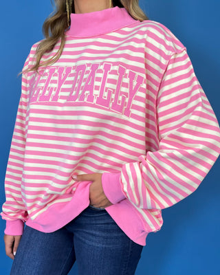 Pink and cream striped Dolly Dally graphic sweatshirt with a mock neckline, long sleeves, contrast pink trim, and relaxed oversized fit.