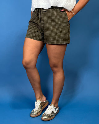 high-rise fit, adjustable tie waist, tailored silhouette, functional pockets, and classic micro polka dot print.