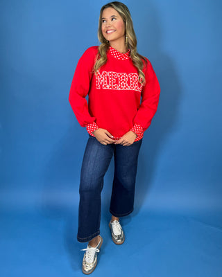 Red Merry graphic sweatshirt with white polka dot lettering, coordinating polka dot mock neckline, cuffs and hem, long sleeves, and a relaxed fit.