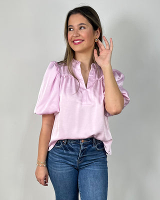 Sweet, silky, and so easy to dress up 💗 This blush satin top features a notched neckline and statement puff sleeves for the perfect mix of polished + playful—just add denim and heels for an effortless day-to-night look!
