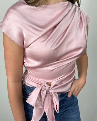 Blush satin tie-front top with a soft draped neckline, styled with cropped raw-hem flare jeans and nude block heels for an easy dressy-casual look. Perfect for date night, brunch, or any event where you want to feel polished without trying too hard.