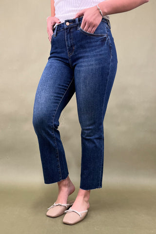Person wearing blue jeans on a beige background