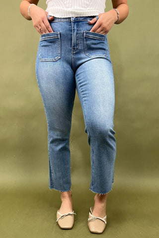 Person wearing blue jeans on a green background