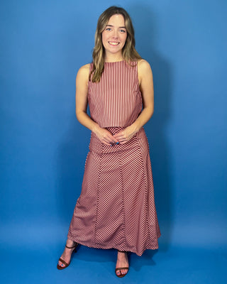 Burgundy and blush striped two-piece set featuring a sleeveless cropped top and coordinating high-waisted maxi skirt with mixed-direction stripe detailing.