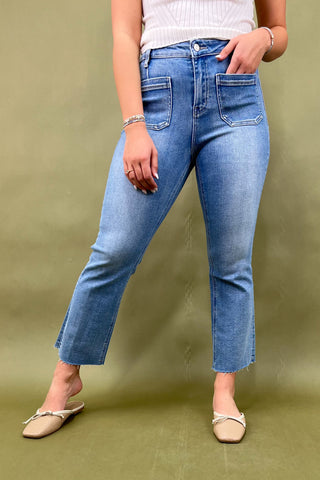 Person wearing blue jeans on a green background