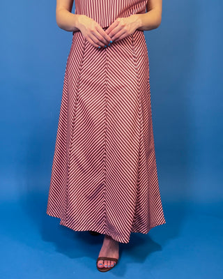 Burgundy and blush striped two-piece set featuring a sleeveless cropped top and coordinating high-waisted maxi skirt with mixed-direction stripe detailing.