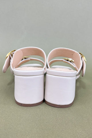 White sandals with pink straps on a gray background