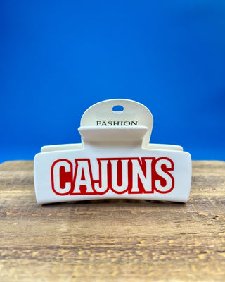White oversized Cajuns claw hair clip with bold red lettering, durable spring hinge, and strong grip teeth for secure everyday styling.