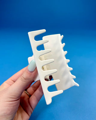 White oversized Cajuns claw hair clip with bold red lettering, durable spring hinge, and strong grip teeth for secure everyday styling.