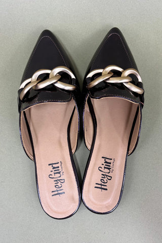 Black pointed-toe shoes with gold chain detail on a light gray background
