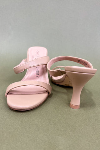 Pink high-heeled sandals on a light gray background