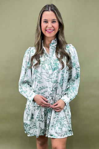 Woman wearing a floral dress against a green background