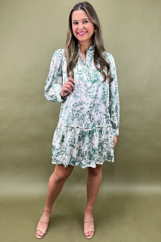 Woman wearing a floral dress against a green background