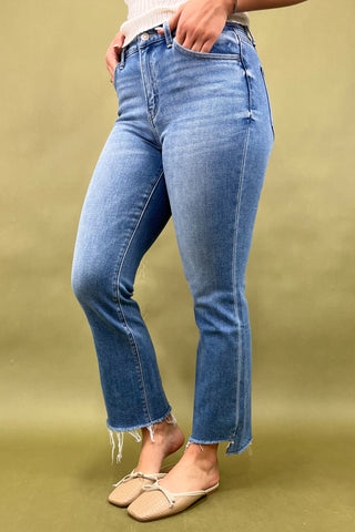 Person wearing blue jeans on a green background