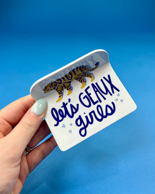White oversized LSU-inspired claw hair clip featuring a "Let's Geaux Girls" design with purple and gold accents and a secure spring hinge.