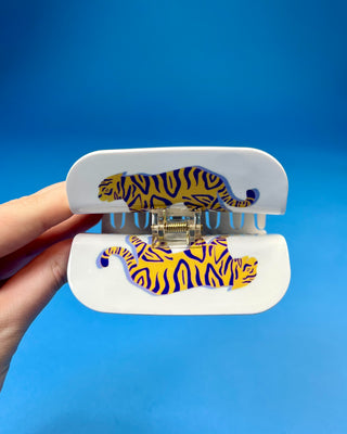White oversized LSU-inspired claw hair clip featuring a "Let's Geaux Girls" design with purple and gold accents and a secure spring hinge.