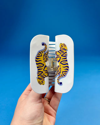 White oversized LSU-inspired claw hair clip featuring a "Let's Geaux Girls" design with purple and gold accents and a secure spring hinge.