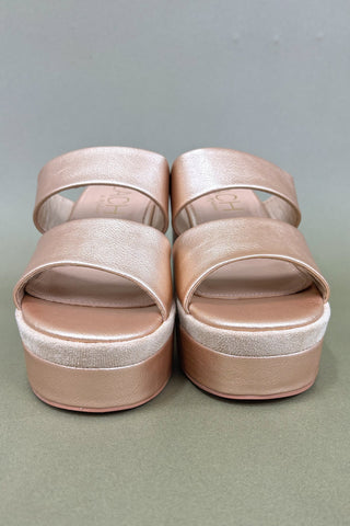 Pair of pink platform sandals on a gray background