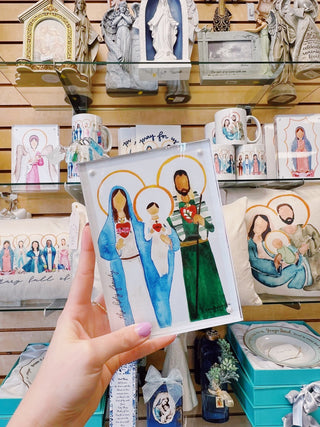 Hand holding artwork in a store setting