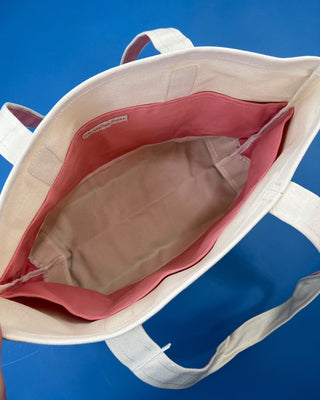 Large heavyweight canvas tote bag with contrast trim, reinforced shoulder straps, exterior slip pocket, and spacious interior available in multiple colors.
