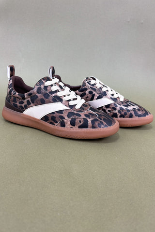 Leopard print sneakers with white laces on a gray background