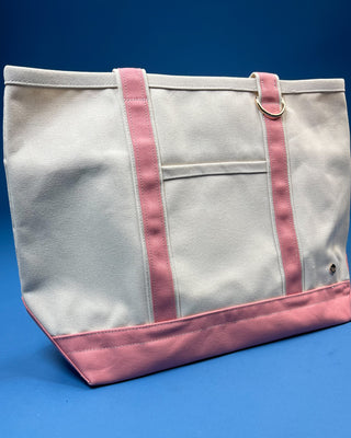 Large heavyweight canvas tote bag with contrast trim, reinforced shoulder straps, exterior slip pocket, and spacious interior available in multiple colors.