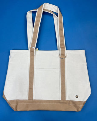 Large heavyweight canvas tote bag with contrast trim, reinforced shoulder straps, exterior slip pocket, and spacious interior available in multiple colors.