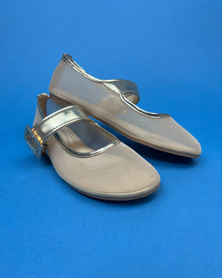 A pair of metallic gold Mary Jane shoes with gold-tone straps and buckles, displayed on a solid blue background.